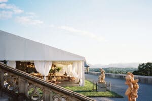 Biltmore Weddings – Marcos and Gaby White reception tent with draped curtains, chandeliers, and mountain views at the Biltmore Estate.
