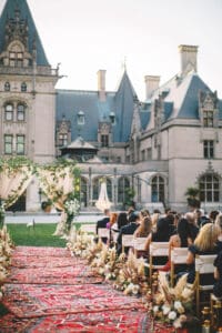 Biltmore Weddings – Marcos and Gaby Guests seated for wedding ceremony facing floral arch at Biltmore Estate.