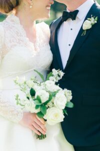 Omni Grove Park Inn Weddings – Ryan and Lauren Bride and groom smiling, holding a white rose bouquet.