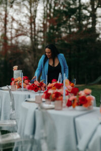 Wedding Planned by Asheville Planner Terran Ward Asheville wedding planner Terran Ward adjusting set-up for wedding reception. Wedding planned by Asheville wedding planner Terran Ward — bold editorial design setup.