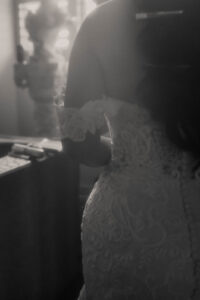 Daniela and Angelo Wedding Grand Bohemian Asheville Black and white close-up of the back of the bride in her lace gown. Wedding Planned by Terran Ward at The Grand Bohemian Asheville