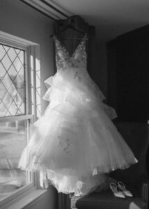 Grand Bohemian Asheville Wedding_Carly and David Black and white photo of wedding dress handing next a window at the Grand Bohemian Asheville. Wedding Planned by luxury Asheville Planner Terran Ward