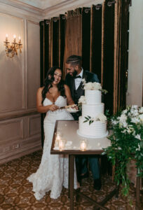 Daniela and Angelo Wedding Grand Bohemian Asheville Bride and groom cutting their cake happily together. Wedding Planned by Terran Ward at The Grand Bohemian Asheville