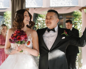 Grand Bohemian Asheville Wedding_Carly and David Close-up of bride and groom smiling as they walk down the aisle at the Grand Bohemian Asheville. Wedding Planned by luxury Asheville Planner Terran Ward