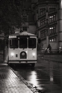Biltmore Estate Asheville Wedding_Heather + Ben Black and white photo of an old bus, outside the Biltmore Estate, on the side of the road in the rain. Wedding rain plan planned by Asheville wedding planner Terran Ward.