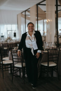 Biltmore Estate Asheville Wedding – Heather and Ben Asheville wedding planner Terran Ward at the Biltmore Estate posing for a photo in the reception room. Wedding planned by Asheville wedding planner Terran Ward — bold editorial design setup.