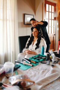 Asheville Mountain Wedding_Kaitlyn and Eric Bride getting her hair done for her mountain wedding. Wedding planned by Asheville wedding planner Terran Ward — bold editorial mountain wedding design.