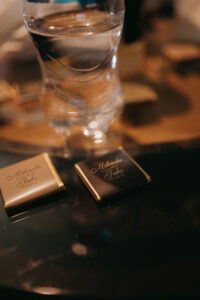 Chestnut Ridge Asheville Wedding_Mikaela + Jacob close-up of custom chocolates with the couple's names. Wedding planned by Asheville wedding planner Terran Ward — bold editorial mountain wedding design.