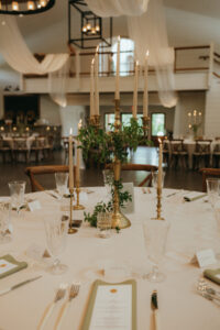 Chestnut Ridge Asheville Wedding_Mikaela + Jacob Romantic table setting with gold candelabra, crystal glassware, and greenery accents at Chestnut Ridge wedding. Wedding planned by Asheville wedding planner Terran Ward — bold editorial mountain wedding design.