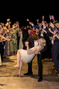 Omni Grove Park Inn Weddings – Mr. and Mrs. Kelly Couple’s grand exit with guests waving American flags at the Omni Grove Park Inn.