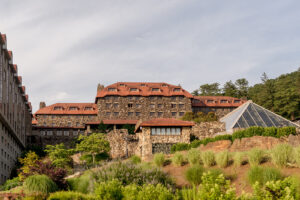 Omni Grove Park Inn Weddings – Mr. and Mrs. Kelly Exterior view of the historic Omni Grove Park Inn surrounded by greenery.