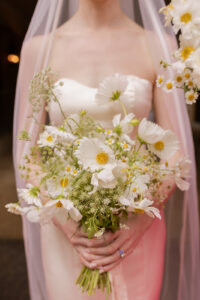 Omni Grove Park Inn Weddings – Mr. and Mrs. Kelly Close-up of bride holding a bouquet of white daisies and cosmos at the Omni Grove Park Inn.