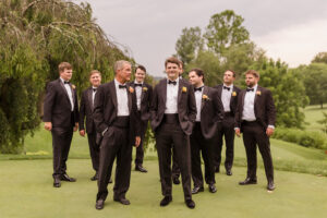 Omni Grove Park Inn Weddings – Mr. and Mrs. Kelly Groom with groomsmen in black tuxedos on the golf course at the Omni Grove Park Inn.