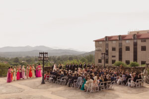 Omni Grove Park Inn Weddings – Mr. and Mrs. Kelly Wide view of wedding ceremony at Omni Grove Park Inn with guests, bridal party, and mountain backdrop.