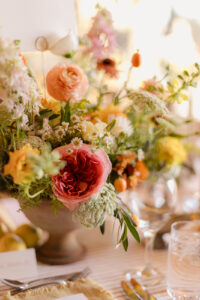 Omni Grove Park Inn Weddings – Mr. and Mrs. Kelly Colorful floral centerpiece with roses, ranunculus, and greenery at the Omni Grove Park Inn.