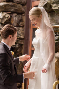 Omni Grove Park Inn Weddings – Mr. and Mrs. Kelly Bride and groom share a joyful moment outside the stone walls of the Omni Grove Park Inn.
