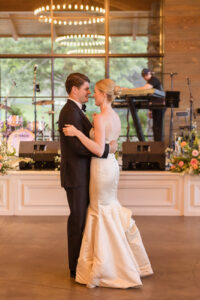 Omni Grove Park Inn Weddings – Mr. and Mrs. Kelly Bride and groom share their first dance under chandeliers at the Omni Grove Park Inn.