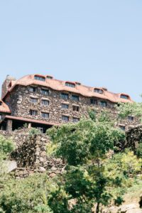 Omni Grove Park Inn Asheville Wedding_Ryan and Lauren Exterior view of the historic Omni Grove Park Inn surrounded by greenery. Wedding planned by Asheville wedding planner Terran Ward — bold editorial mountain wedding design.