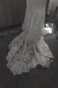 Daniela and Angelo Wedding Grand Bohemian Asheville Black and white photo of a close-up of the bride's short lace dress train. Wedding Planned by Terran Ward at The Grand Bohemian Asheville