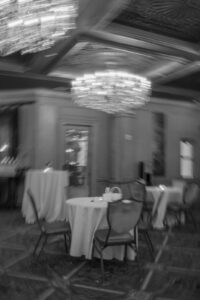 Daniela and Angelo Wedding Grand Bohemian Asheville Blurry black and white photo of small, round reception tables. Wedding Planned by Terran Ward at The Grand Bohemian Asheville