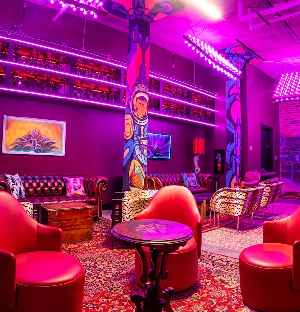 Neon lit reception room with funky furniture at the radical hotel. Wedding planned by Terran Ward.