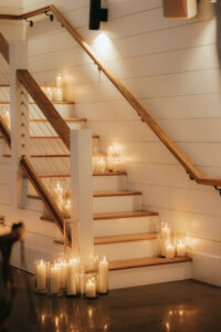 Candles lining staircase at the Chestnut Ridge. Destination wedding in Asheville — Terran Ward planning mountain ceremony