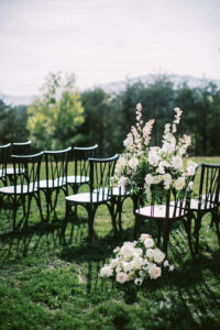Micro wedding outdoor ceremony set up featuring black chairs and white florals. Asheville micro wedding — modern editorial setup by Terran Ward
